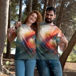 Home 4 Couple wearing colorful abstract print T-shirts outdoors in a forest setting.