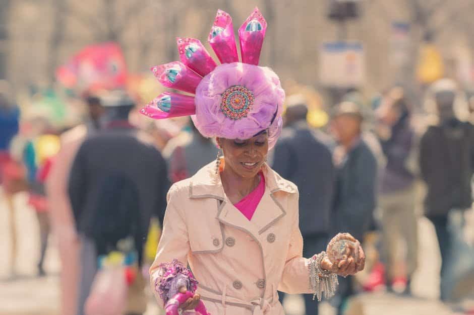 The Importance of Staying Updated on Fashion Trends Woman in colorful festival costume with pink headpiece at outdoor event.